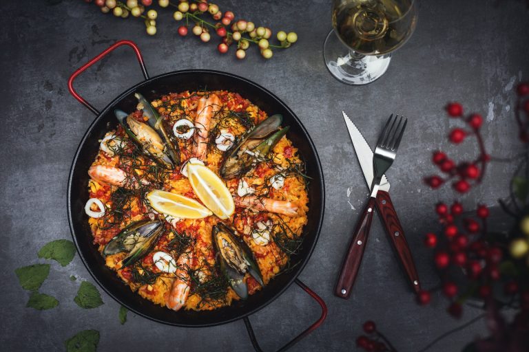 Spanish paella on desk with fork and knife